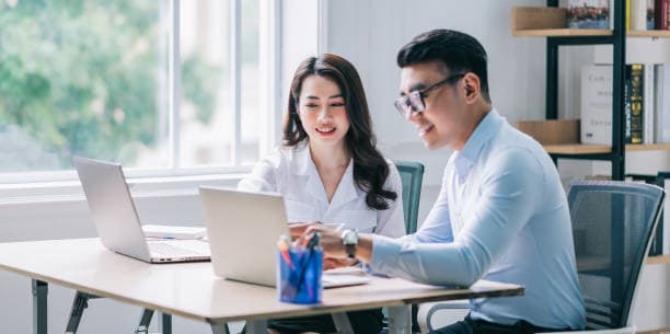 Two people working together at a desk